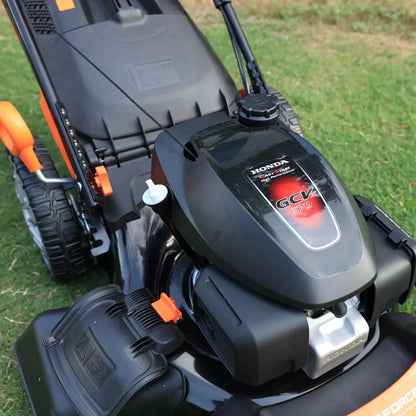 YardForce 167cc Honda engine self-propelled petrol lawn mower with 51cm cutting width mowing a large residential lawn
