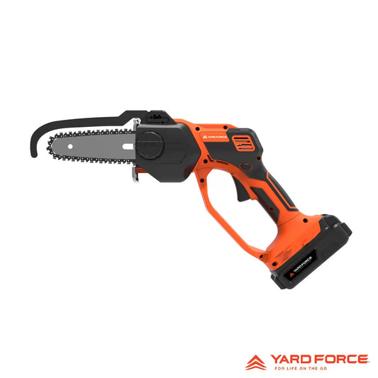 A person using the Yard Force 20V mini chainsaw to prune a thick branch from a garden tree using one hand.