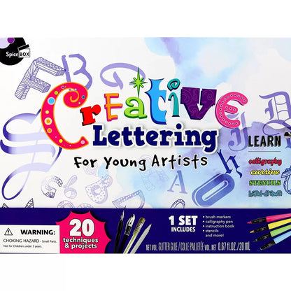 Young Artist Creative Lettering box open on a wooden desk showing brush markers, dip pen with ink bottle, stencils, and a completed colorful calligraphy pad.