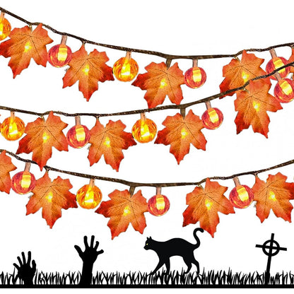 A 20 LED ZOELNIC orange maple leaf string light glowing warmly along a decorated wooden porch railing.