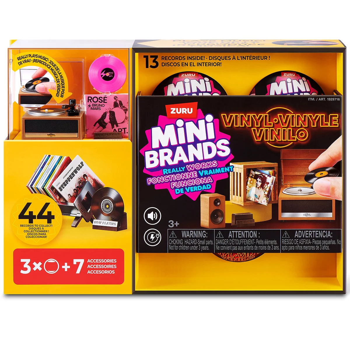 Three colorful ZURU Mini Brands mystery capsules set next to a tiny working black and red mini record player with mini vinyl records spread across a white surface.