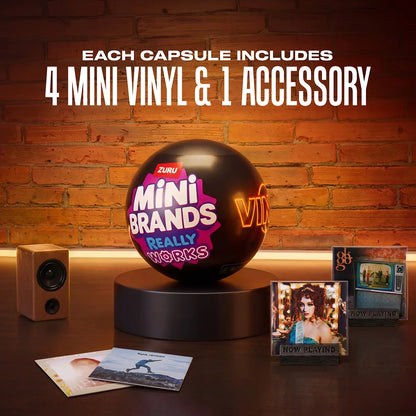 Three colorful ZURU Mini Brands mystery capsules set next to a tiny working black and red mini record player with mini vinyl records spread across a white surface.