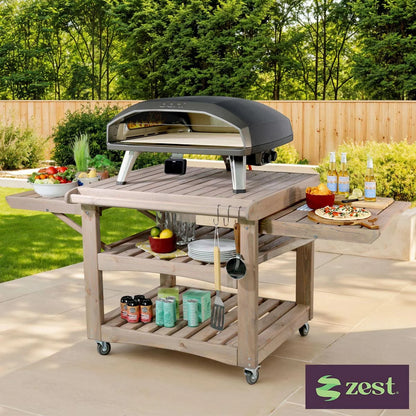 Zest Garden Drop Leaf Table with one leaf folded down, placed on a small wooden patio for flexible outdoor dining.