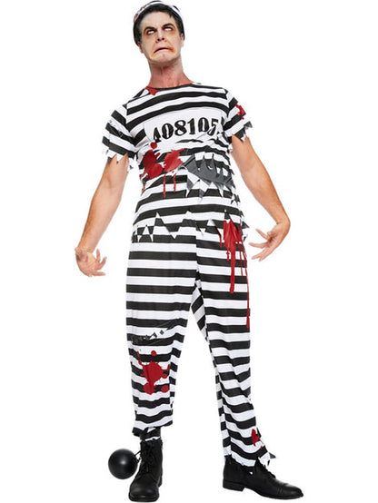Front view of adult wearing a tattered black and white striped zombie convict costume with bloody splatters in a dimly lit studio setting.