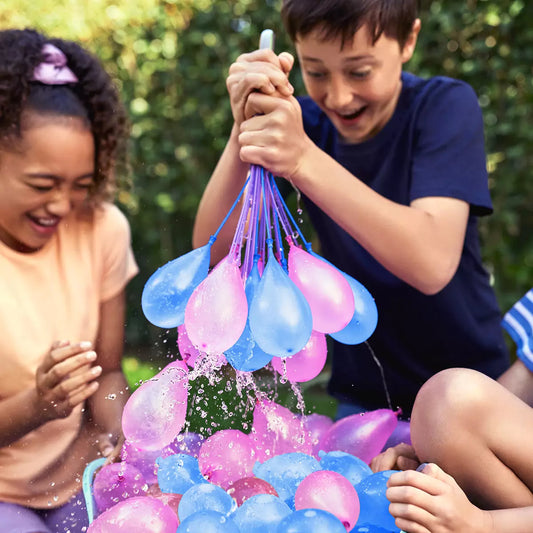 Large bundle of vibrant Zuru Bunch O Balloons in tropical neon colors being filled simultaneously from a garden hose.