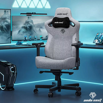 Front angle view of the grey linen fabric anda seaT Kaiser Series 3 large gaming chair showing the magnetic neck pillow and 4D armrests in a brightly lit modern office setup.