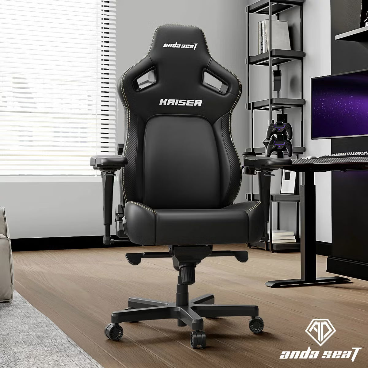 Front three-quarter angle view of the black anda seaT Kaiser Series 4 large gaming chair showing the sleek synthetic leather finish and magnetic neck pillow in a modern gaming setup.