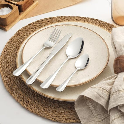 Top-down view of the 24-piece silver Salter Newbury stainless steel cutlery set with mirror finish arranged neatly on a dark wooden dining table.
