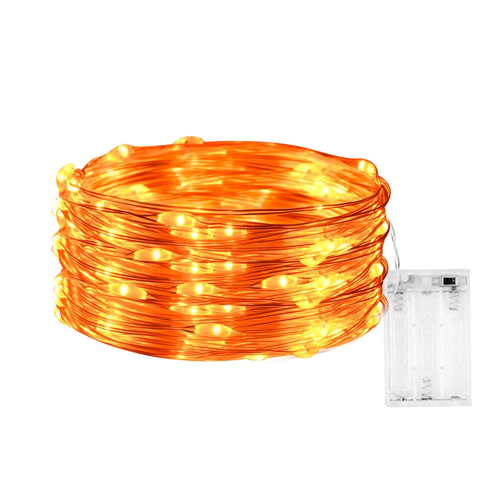 A 3-meter strand of 30 orange LED fairy lights on micro silver wire glowing softly around an indoor window frame.
