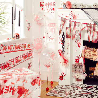 Realistic bloody handprint static cling stickers displayed on a clear glass window during a Halloween setup.