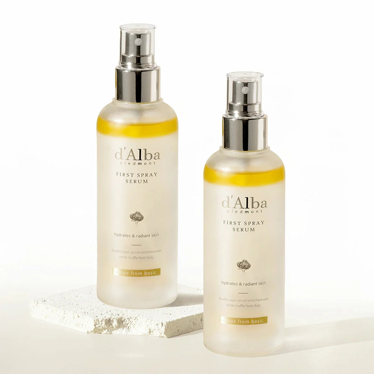 Two 180ml bottles of d'Alba White Truffle First Spray Serum displayed elegantly, highlighting the dual-phase liquid formula.