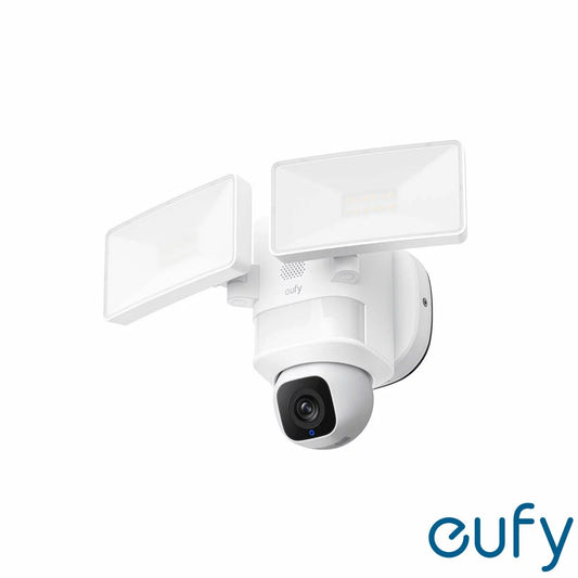 White eufy Floodlight Cam E30 smart security camera featuring twin adjustable LED floodlight panels and a central motorized 2K camera lens mounted on a dark exterior wall.