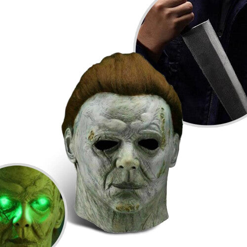 Front angle view of a realistic white Michael Myers horror latex mask featuring dark synthetic hair and aged detailing on a dark background.