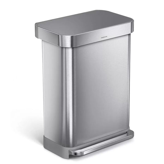 Front angle view of the simplehuman 55L brushed stainless steel step bin with grey plastic lid set against a bright modern kitchen backdrop.
