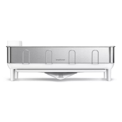 simplehuman stainless steel dish rack with swivel spout drainer on a clean kitchen countertop