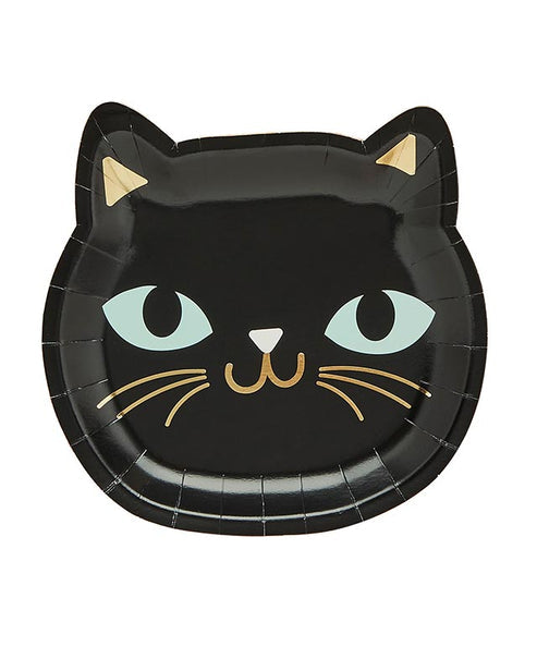 Pack of eight round black cat paper plates for Halloween parties displayed on a wooden table setup.