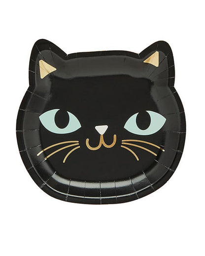 Pack of eight round black cat paper plates for Halloween parties displayed on a wooden table setup.